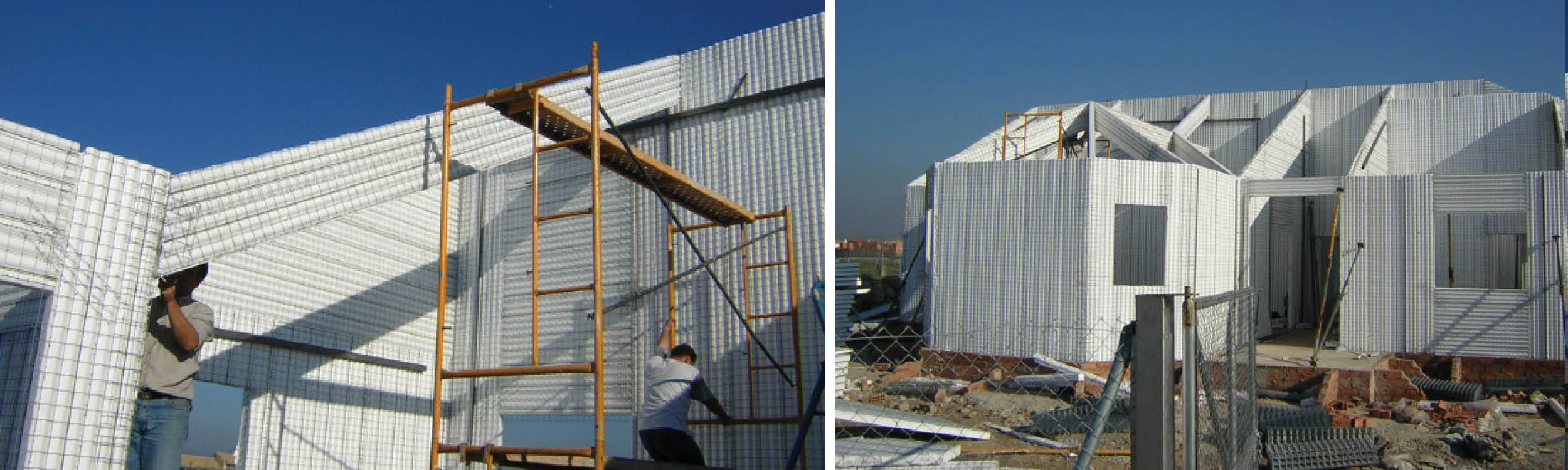 Worker assembling metal framework beside a large corrugated metal building.