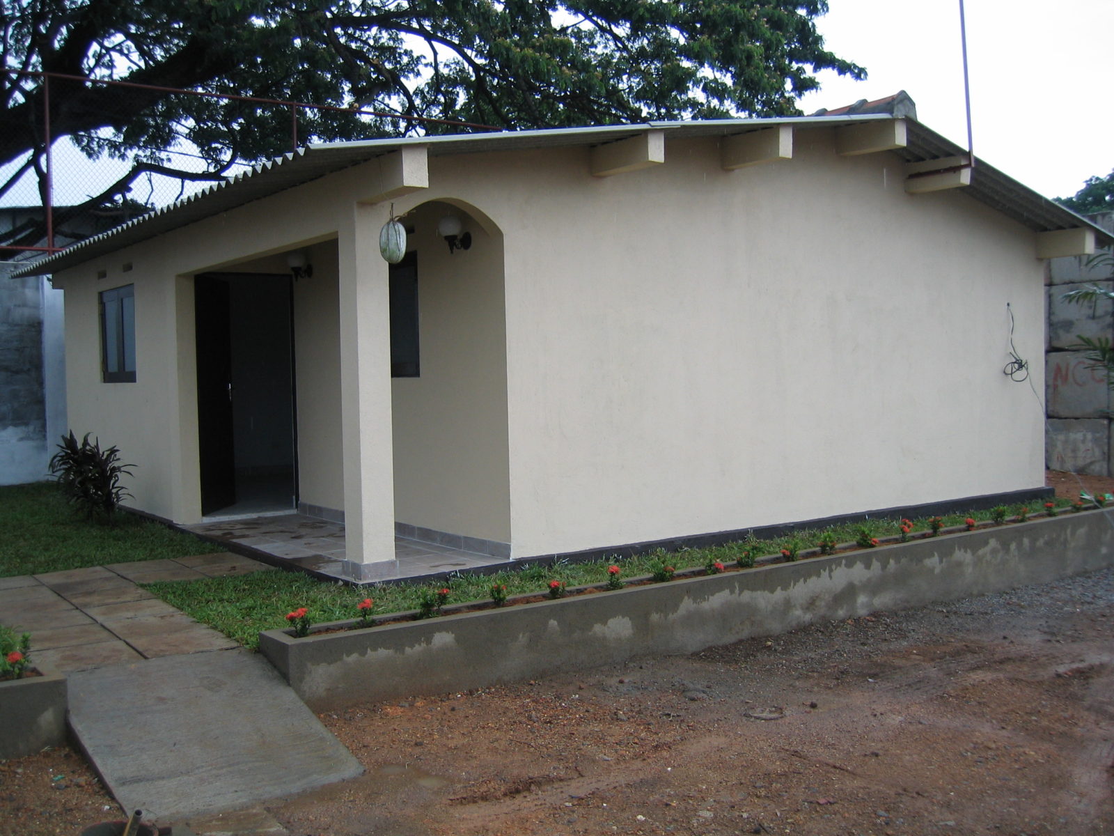 Small beige house with simple front yard.