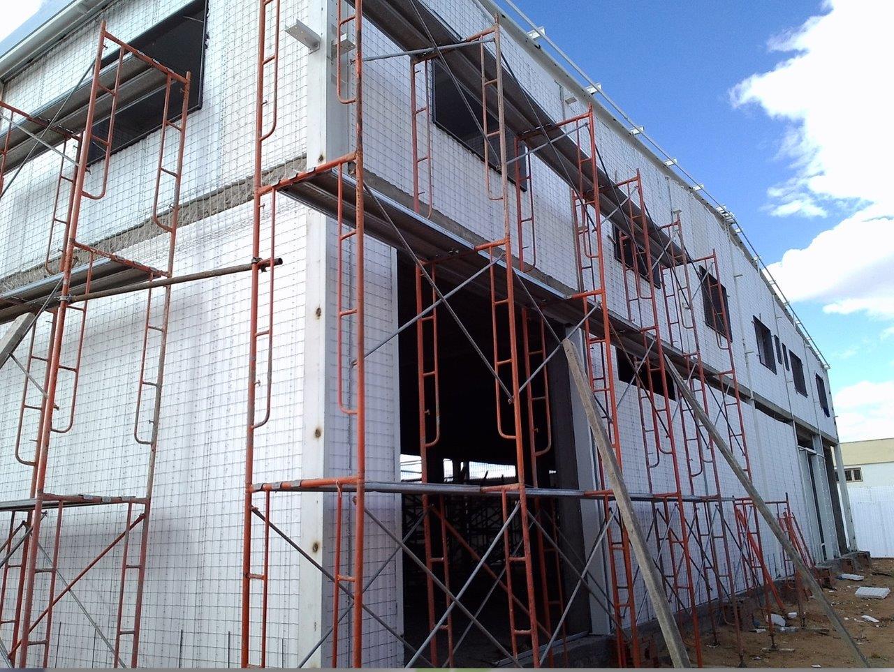 Building under construction with scaffolding structures.