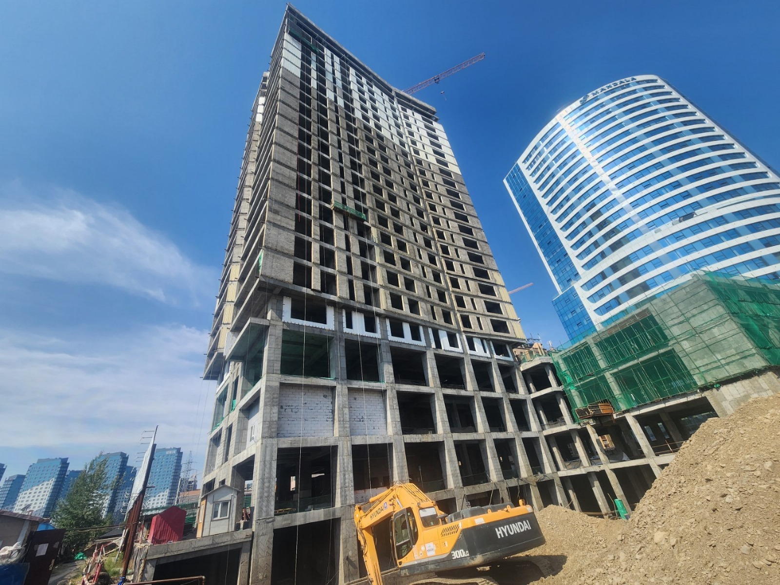 High-rise building under construction with crane.