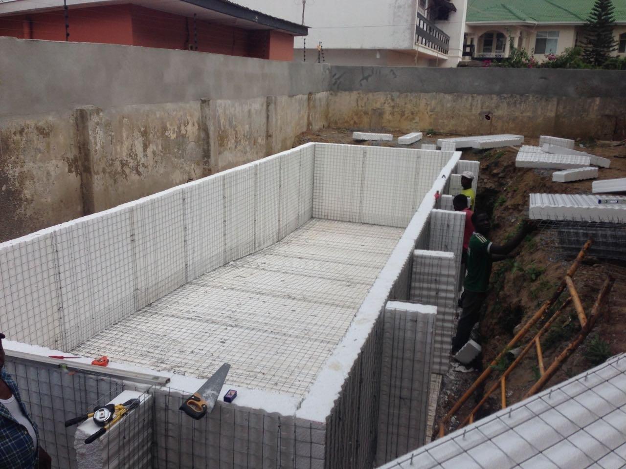 Construction site with rectangular foundation structure.